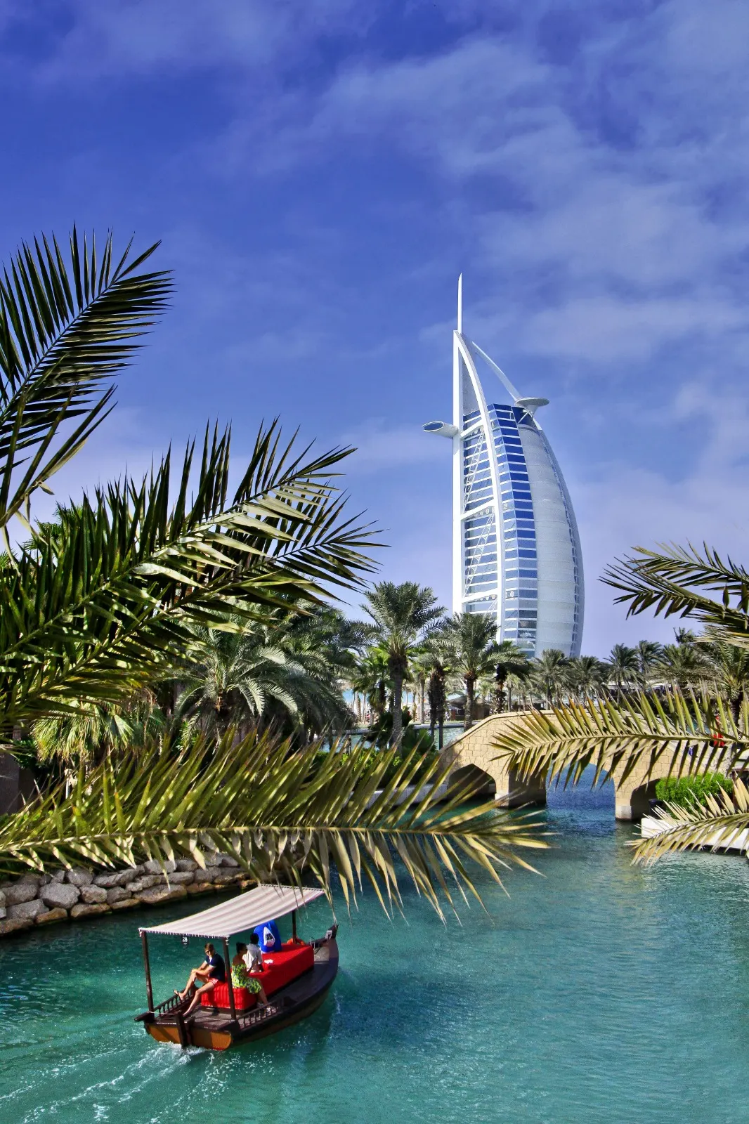 Palm trees framing a landmark hotel by the sea