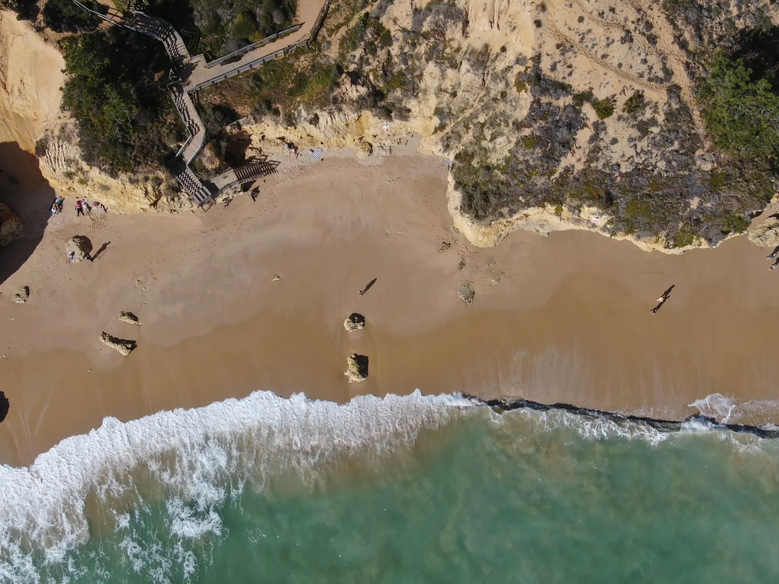 Aerial view of waves on a golden beach