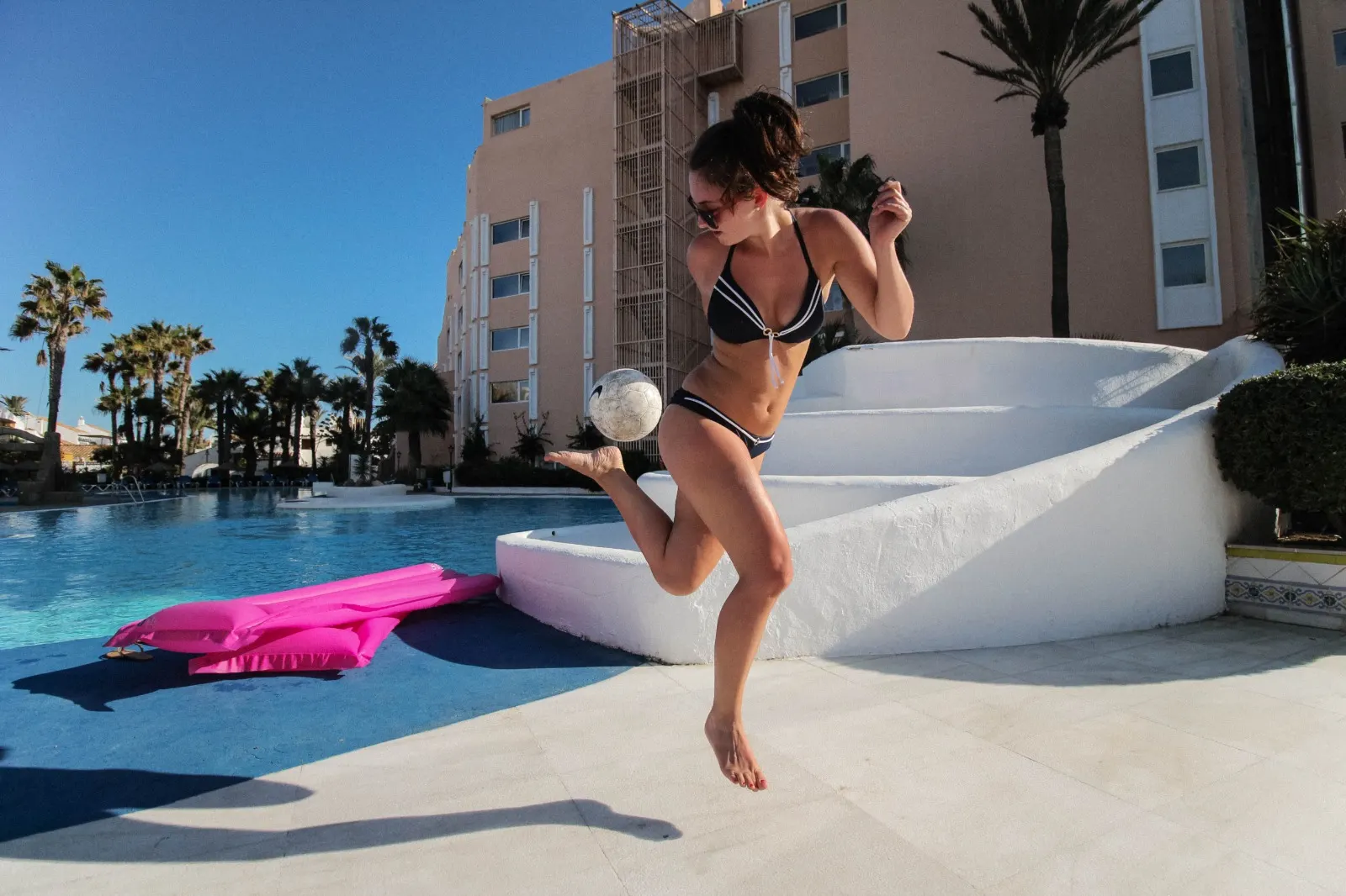 Holidaymaker having fun by a sunny pool