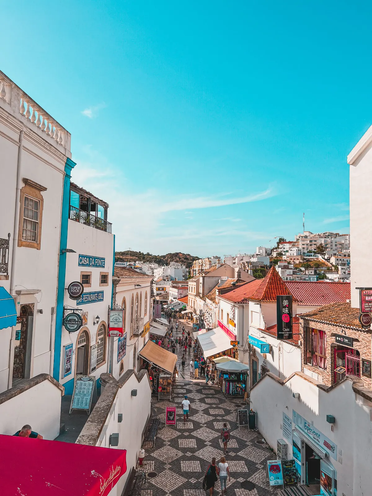 Colourful old town street running down to the sea