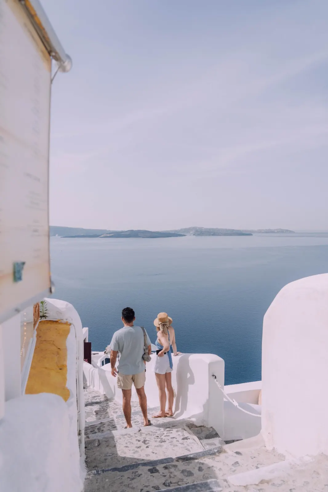 Couple enjoying a sea view from whitewashed terraces